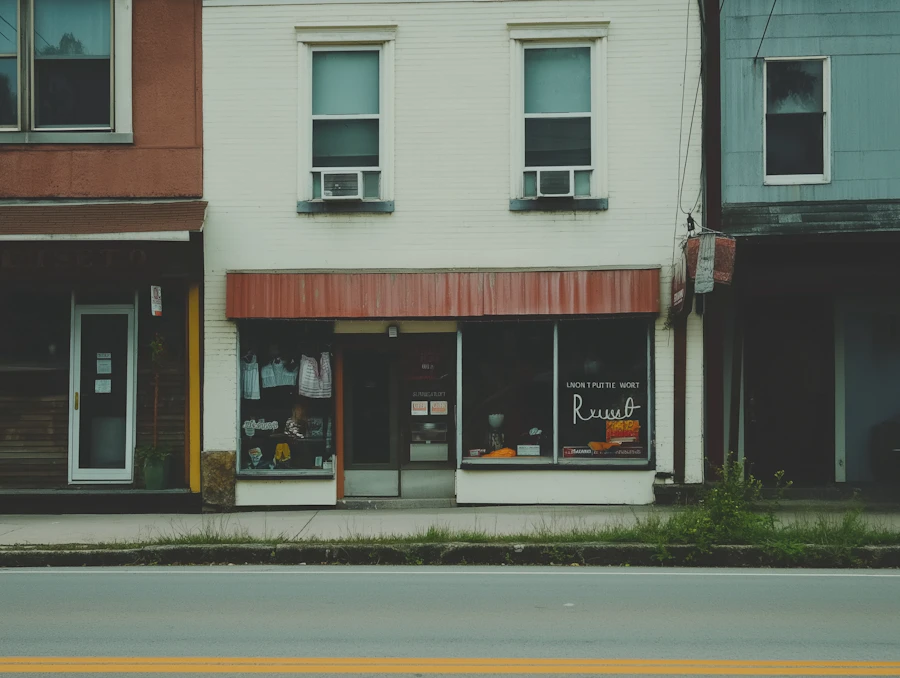 A small downtown storefront with a red awning and a sign taped to the window