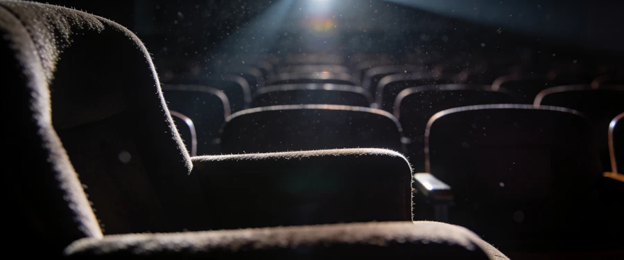 An empty theater stage lit by a single spotlight