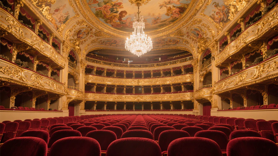 Ornate interior of a community theater with rows of seating facing the stage