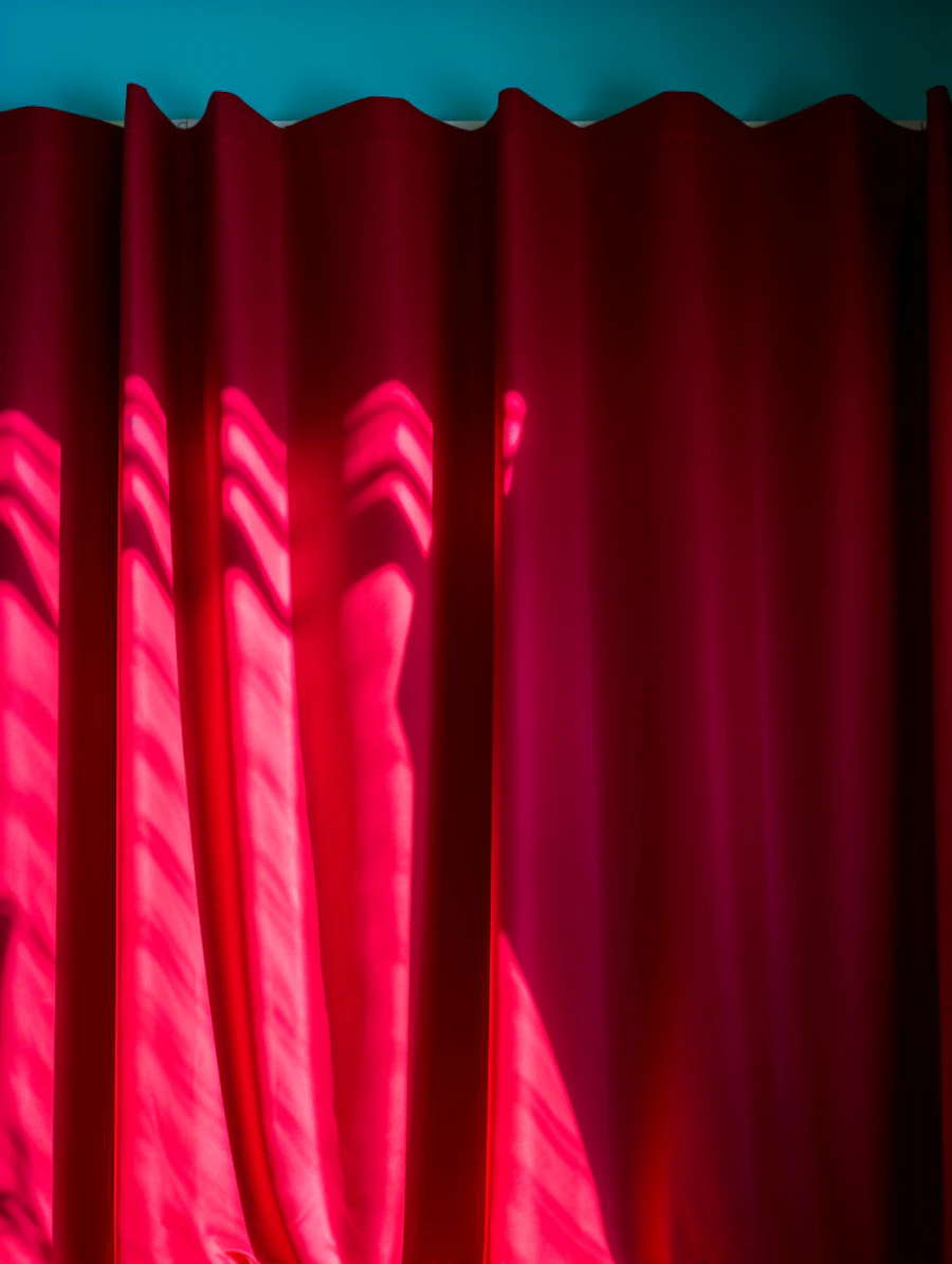 A red theater curtain on a community theater stage