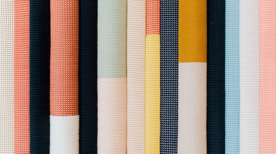 Rolls of colorful fabric bolts stacked side by side