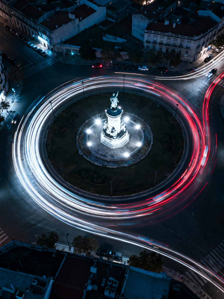 An illuminated roundabout intersection at dusk
