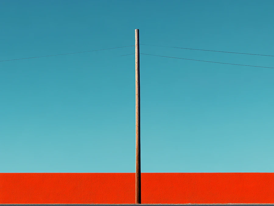 A utility pole against a blue sky, the kind that held one of the city's nine Flock Safety camera units