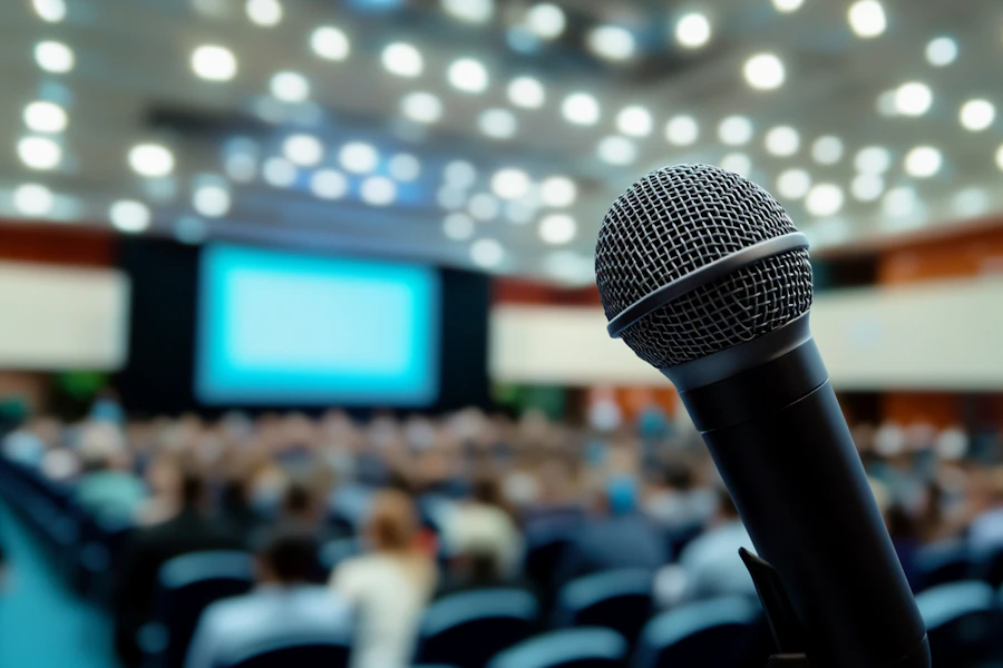 A podium with microphones set up for a candidate forum