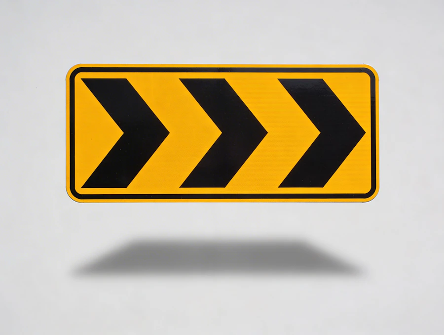 A yellow chevron road sign indicating a directional detour