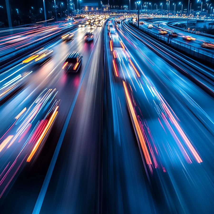 A freeway at night with light trails from passing traffic