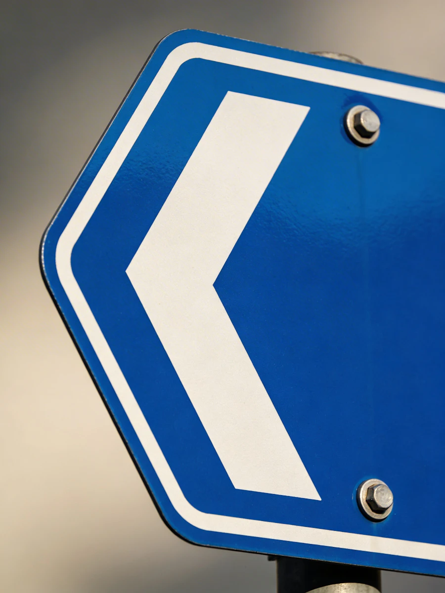 A directional arrow sign at a downtown Waukesha intersection